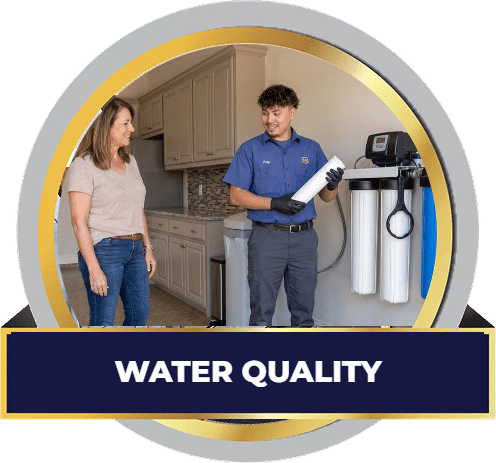 CW Service Pros technician reviewing a whole home water filtration system with a homeowner